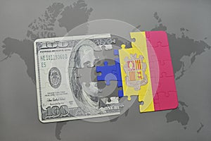 puzzle with the national flag of andorra and dollar banknote on a world map background.