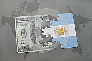 puzzle with the national flag of argentina and dollar banknote on a world map background.