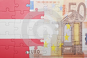 Puzzle with the national flag of austria and euro banknote