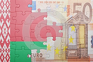 Puzzle with the national flag of belarus and euro banknote