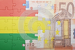 Puzzle with the national flag of bolivia and euro banknote