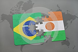 puzzle with the national flag of brazil and niger on a world map background. photo