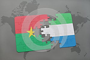 puzzle with the national flag of burkina faso and sierra leone on a world map