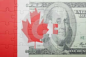 Puzzle with the national flag of canada and dollar banknote