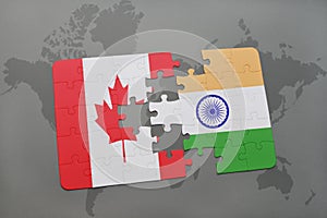 puzzle with the national flag of canada and india on a world map background.