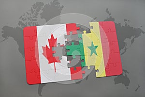 puzzle with the national flag of canada and senegal on a world map background.