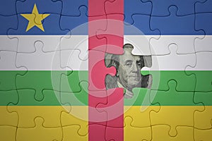 puzzle with the national flag of central african republic and usa dollar banknote. finance concept