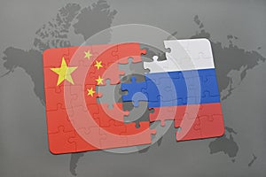 puzzle with the national flag of china and russia on a world map background.