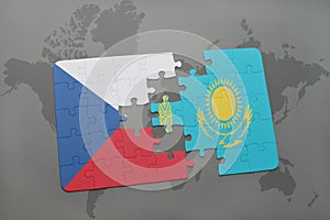 puzzle with the national flag of czech republic and kazakhstan on a world map background.