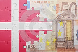 Puzzle with the national flag of denmark and euro banknote