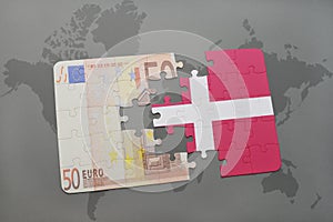 puzzle with the national flag of denmark and euro banknote on a world map background.