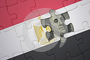 puzzle with the national flag of egypt and usa dollar banknote. finance concept