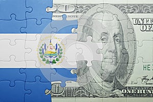 Puzzle with the national flag of el salvador and dollar banknote