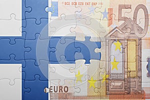 Puzzle with the national flag of finland and euro banknote
