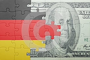 Puzzle with the national flag of germany and dollar banknote