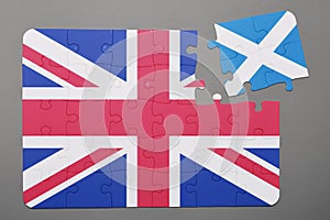 Puzzle with national flag of great britain and scotland piece detached.