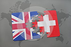 puzzle with the national flag of great britain and switzerland on a world map background
