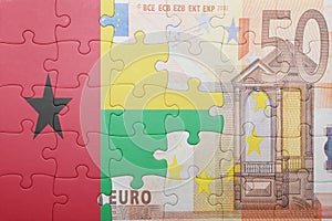 Puzzle with the national flag of guinea bissau and euro banknote