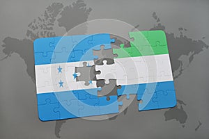 puzzle with the national flag of honduras and sierra leone on a world map