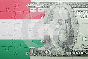 Puzzle with the national flag of hungary and dollar banknote