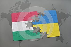 Puzzle with the national flag of hungary and ukraine on a world map background.
