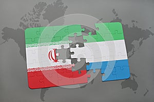 puzzle with the national flag of iran and sierra leone on a world map background.