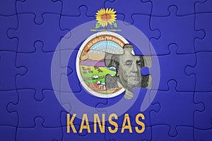 puzzle with the national flag of kansas state and usa dollar banknote. finance concept