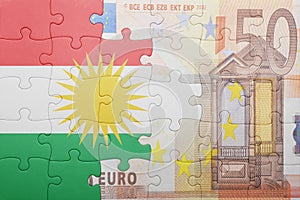 Puzzle with the national flag of kurdistan and euro banknote
