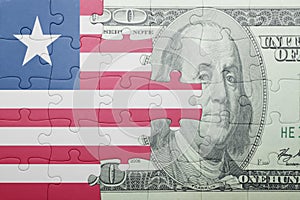 Puzzle with the national flag of liberia and dollar banknote