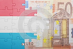 Puzzle with the national flag of luxembourg and euro banknote