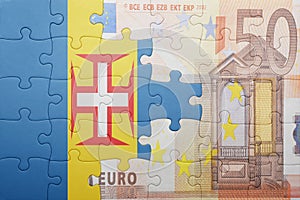 Puzzle with the national flag of madeira and euro banknote