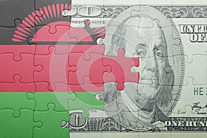 Puzzle with the national flag of malawi and dollar banknote