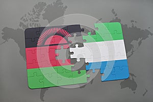 puzzle with the national flag of malawi and sierra leone on a world map