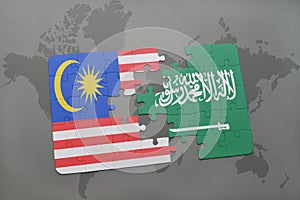 puzzle with the national flag of malaysia and saudi arabia on a world map background.
