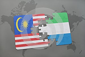 puzzle with the national flag of malaysia and sierra leone on a world map background.