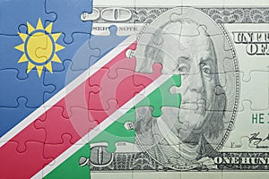 Puzzle with the national flag of namibia and dollar banknote