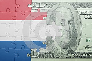 Puzzle with the national flag of netherlands and dollar banknote