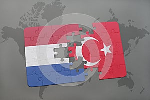 puzzle with the national flag of netherlands and turkey on a world map background.