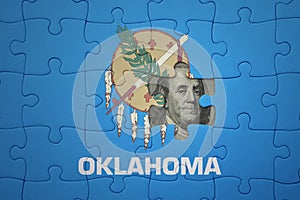 puzzle with the national flag of oklahoma state and usa dollar banknote. finance concept