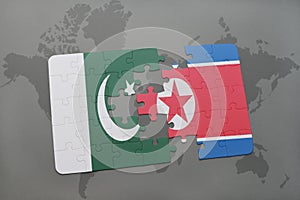 puzzle with the national flag of pakistan and north korea on a world map background.
