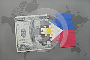 puzzle with the national flag of philippines and dollar banknote on a world map background. photo