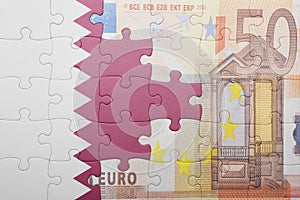 Puzzle with the national flag of qatar and euro banknote