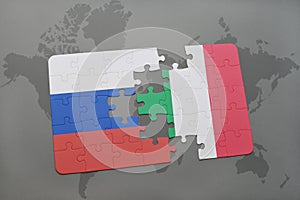 puzzle with the national flag of russia and italy on a world map background.