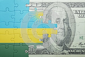 Puzzle with the national flag of rwanda and dollar banknote