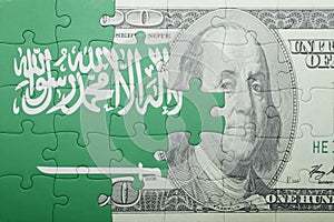 Puzzle with the national flag of saudi arabia and dollar banknote