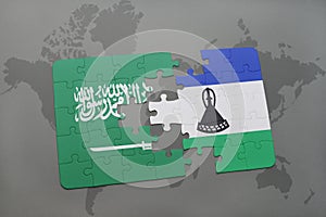 puzzle with the national flag of saudi arabia and lesotho on a world map background.