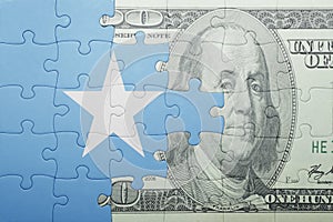 Puzzle with the national flag of somalia and dollar banknote