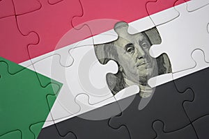 puzzle with the national flag of sudan and usa dollar banknote. finance concept