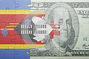 Puzzle with the national flag of swaziland and dollar banknote