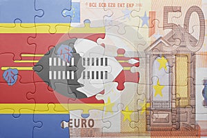 Puzzle with the national flag of swaziland and euro banknote